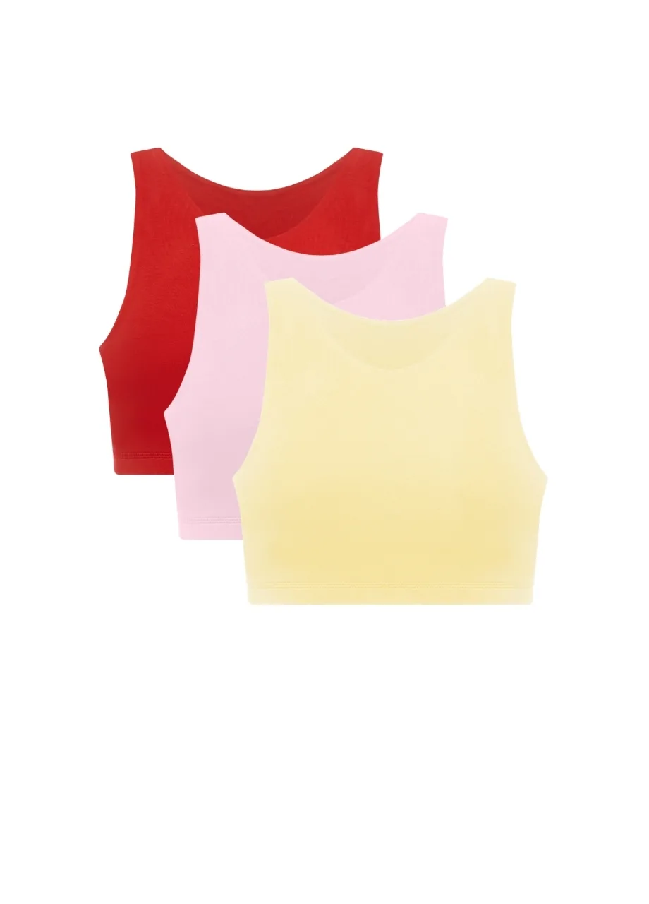 1 › Str/Cd Wear Three pastel sleeveless crop tops layered: red, pink, and yellow.