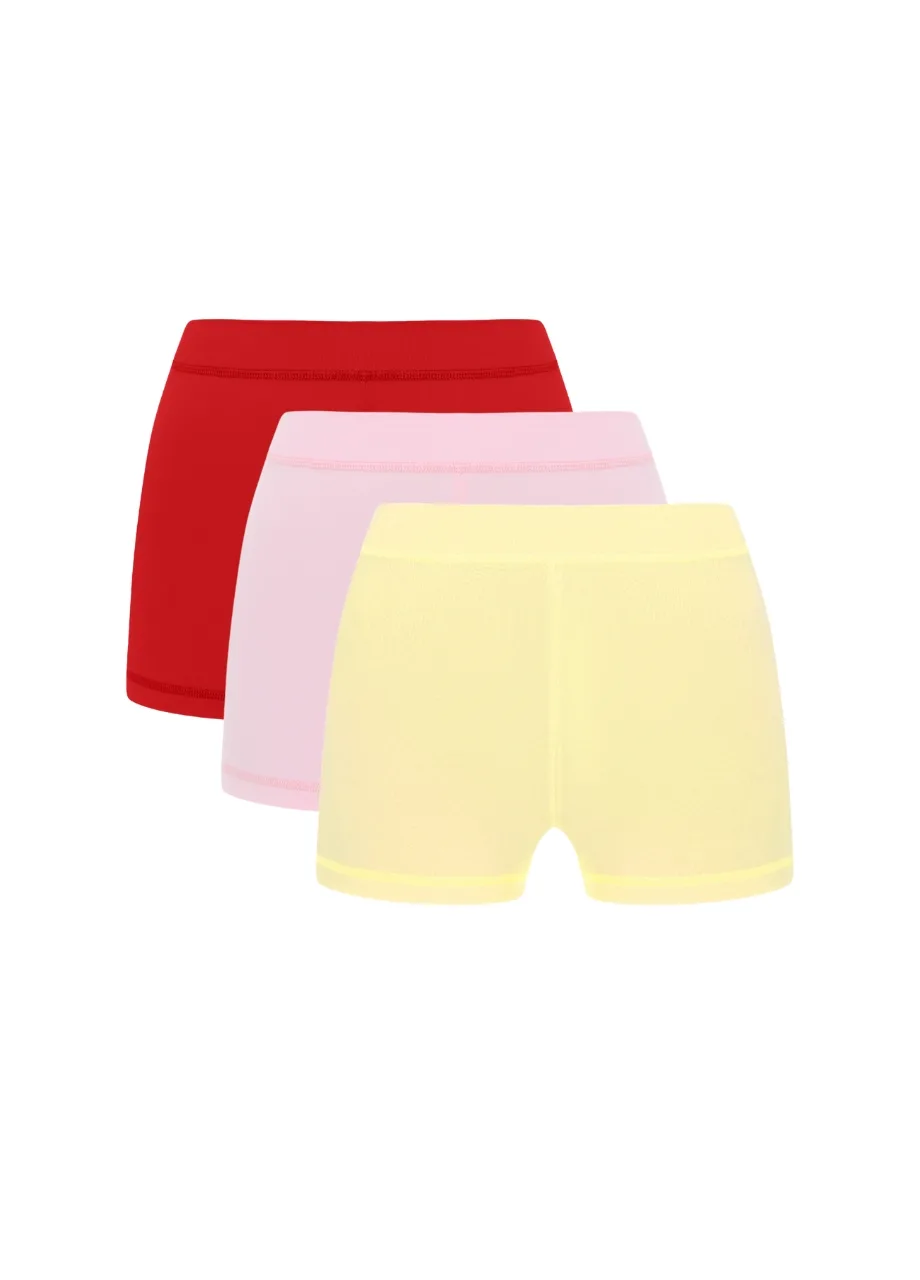 1 › Str/Cd Wear Three pairs of shorts in red, pink, and pale yellow stacked together in a simple display.