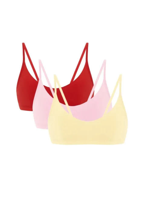 Three pastel bralettes (red, pink, and pale yellow) layered together.