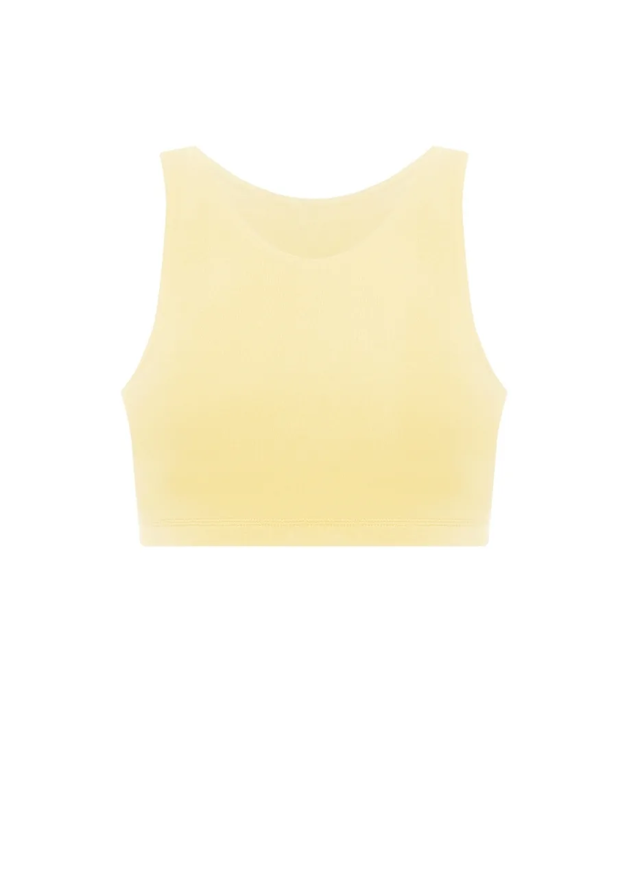 14 › Str/Cd Wear Pale yellow cropped sports bra on a white background.