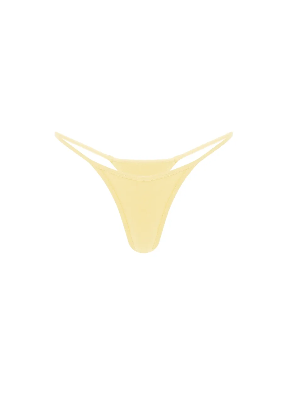 15 › Str/Cd Wear Light-yellow thong-style bikini bottom with thin side straps on a white background.