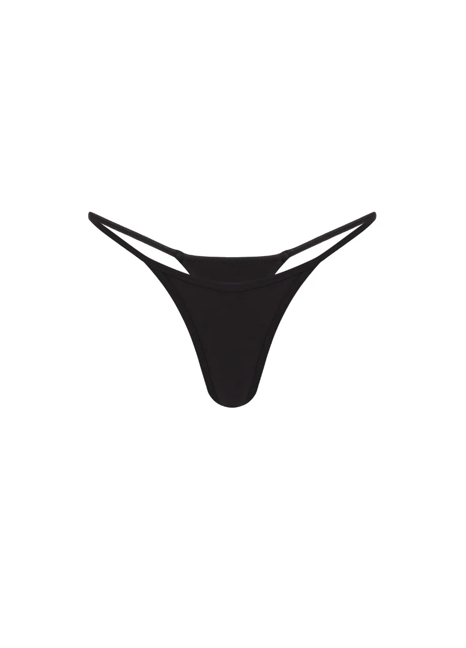 16 › Str/Cd Wear Black thong-style bikini bottom with narrow double side straps on a white background.