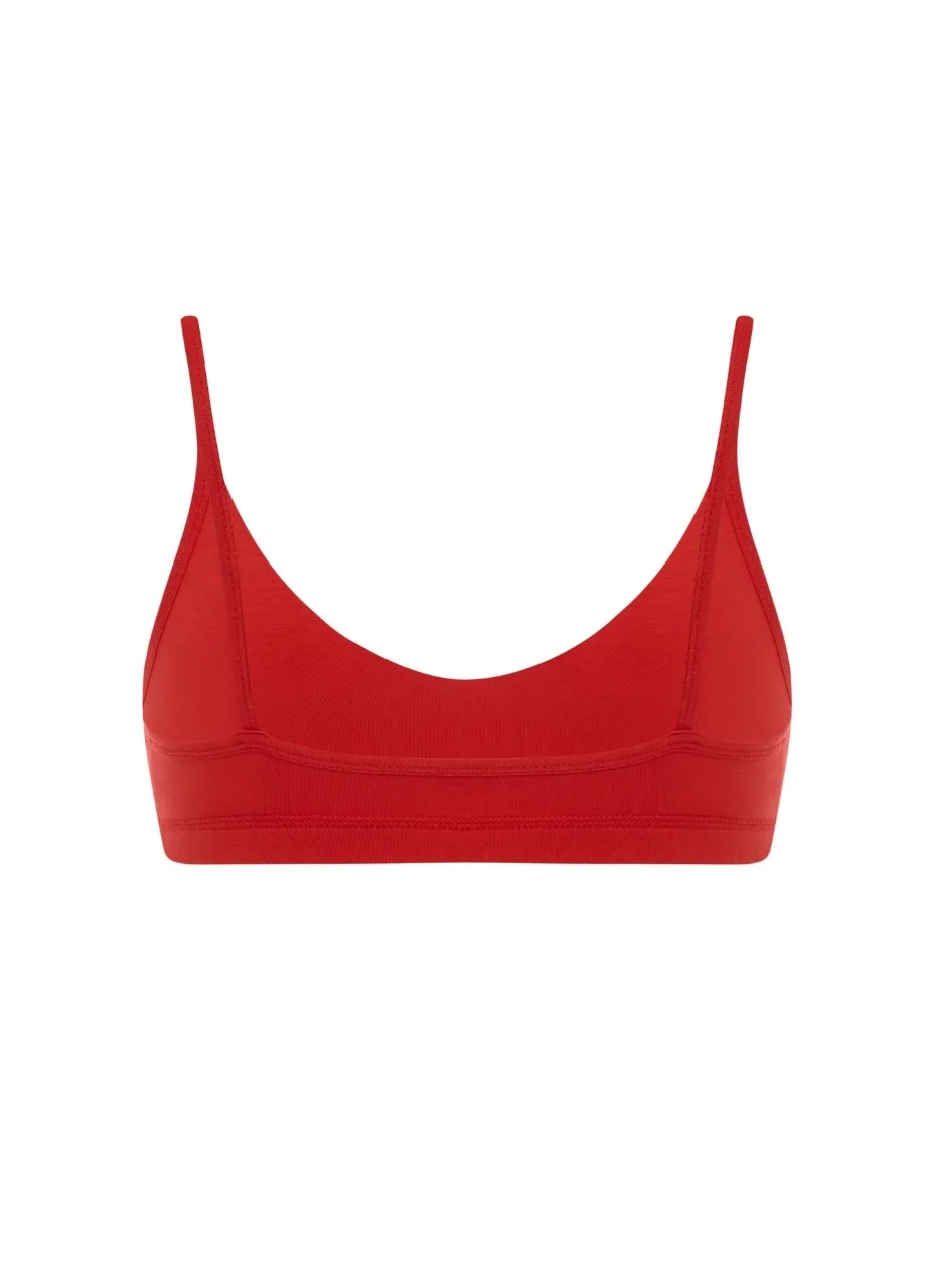 19 › Str/Cd Wear Red sports bra with thin straps and a scoop neckline on a white background on white backdrop, front view.