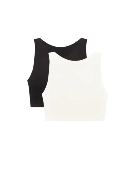 Two sleeveless cropped tops layered together—black top behind a white/ivory one, showing a two-tone fashion layer.