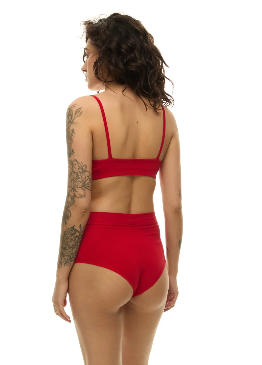 WP611218 › Str/Cd Wear Woman shown from behind wearing a red bikini; short wavy hair and a tattoo sleeve on her left arm visible