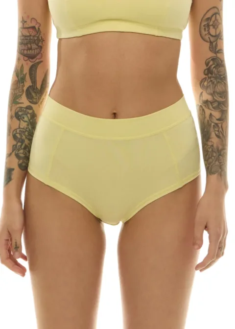 Model wearing pale yellow high-waisted underwear and matching sports bra; torso shot focusing on the midsection.