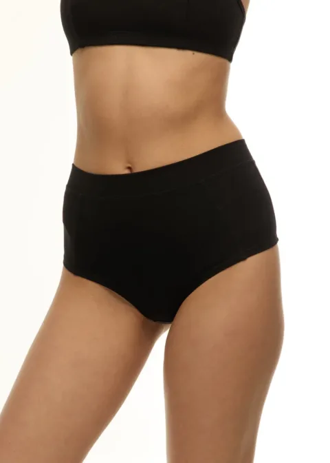Woman wearing black high-waisted underwear, shown from midriff to thighs against a light background.