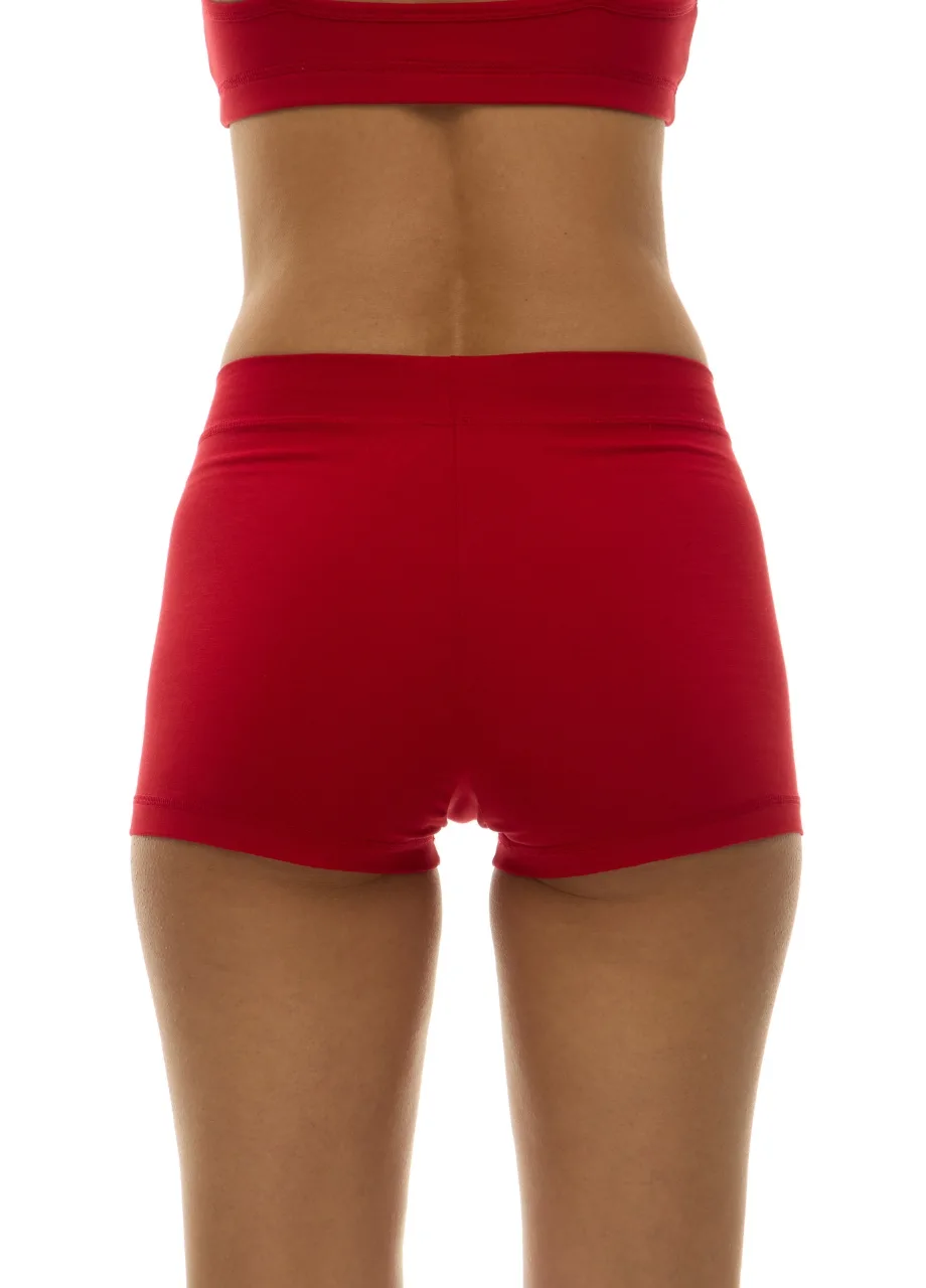 WU1313019 › Str/Cd Wear Back view of a person in a red sports bra and red athletic shorts, standing against a white background.