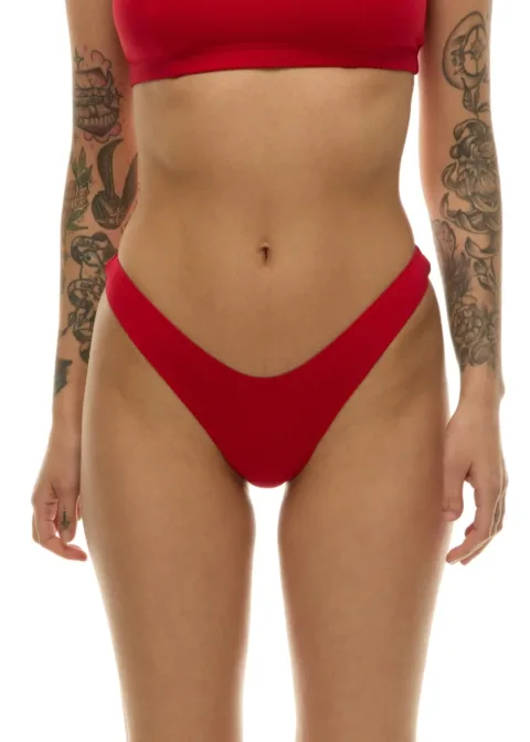 Front view of a person wearing a red bikini top and high-cut red bottoms, with tattoos on both arms visible.