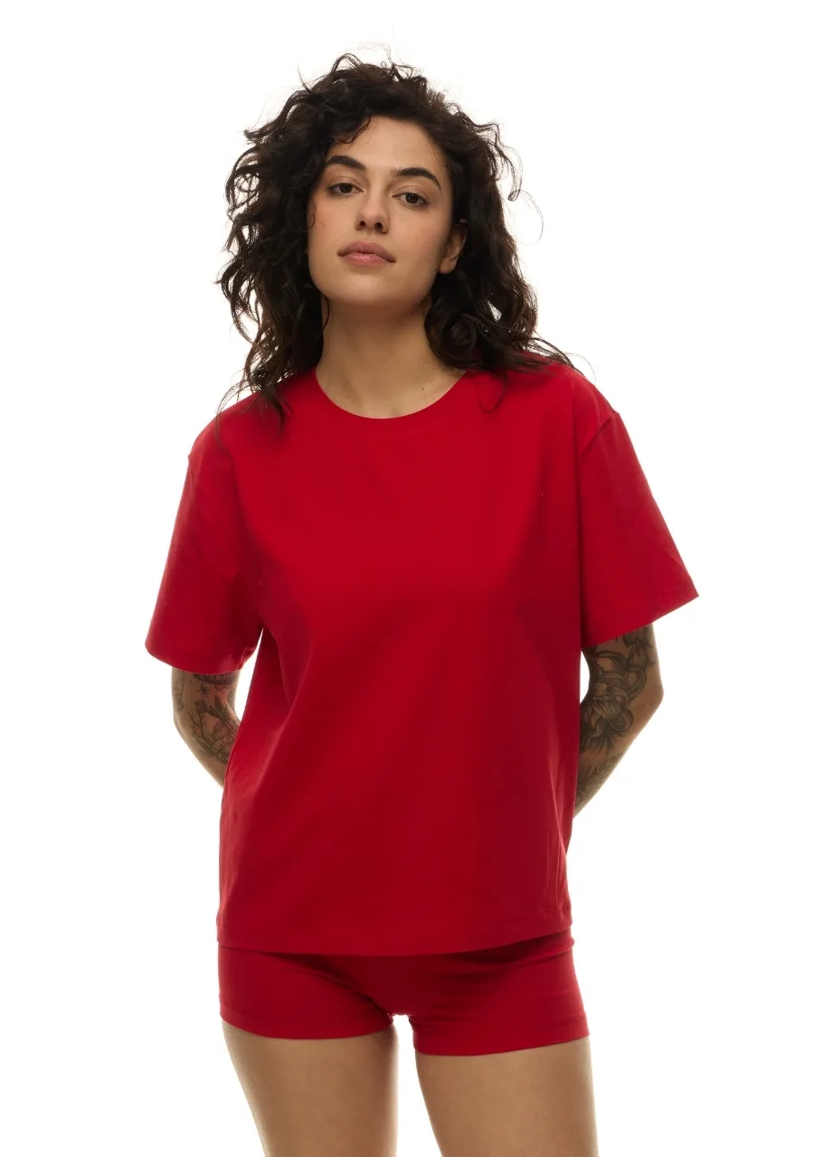 52 › Str/Cd Wear Person standing in a bright red casual outfit: loose red T-shirt and matching red shorts, against a white background