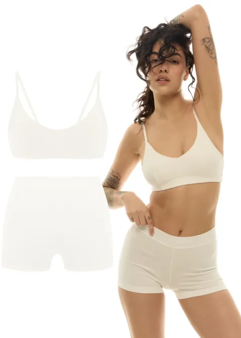 Model wearing a nude-colored bra and matching high-waisted shorts; two-tone product cutouts of the same set appear on the left.